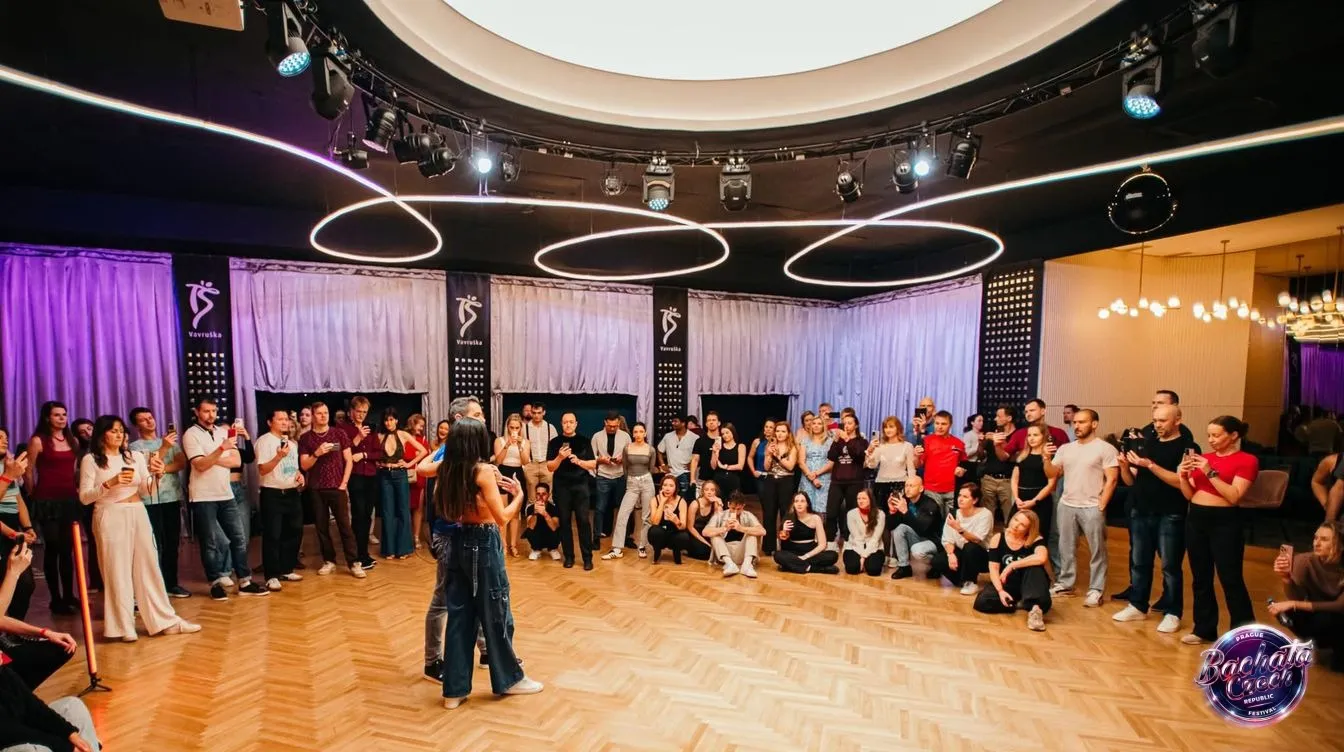 A circle of dancers watching a dancer in the middle of the floor at a Bachata Czech Republic event in Prague
